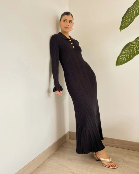 Vestido largo negro T.202 de PRIMIA con cuello tipo polo, botones dorados y puños con volantes, vista de cuerpo completo.