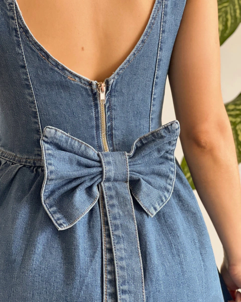 Detalle posterior del vestido T.174 de PRIMIA con cierre central y lazo grande de denim con tiras largas.