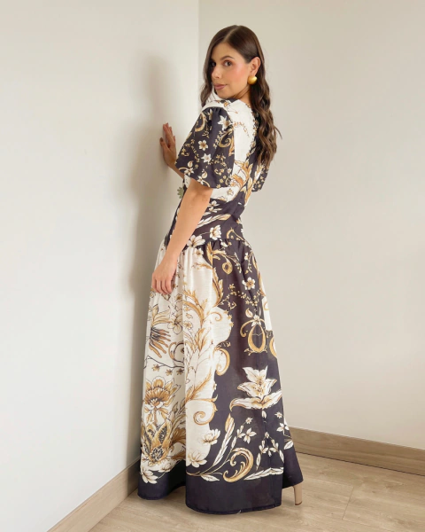 Vestido T.146 de PRIMIA, vista lateral en ángulo que muestra el estampado floral de la falda, las mangas cortas y el contraste de paneles claros y oscuros.