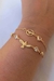 PULSEIRA DIVINO ESPIRITO SANTO COM PONTOS DE LUZ BANHADA A OURO 18K - comprar online