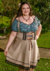 Descubra o Traje Blume Avelã Plus com corpete, saia e suspensórios. Conforto e estilo em um único look! Clique agora e monte seu traje!