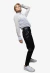 Modelo luciendo una camisa de gasa blanca a rayas con pantalones de cuero negro y zapatillas blancas.