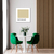 Quadro decorativo com a inscrição "Café Au Lait" em um ambiente moderno, com mesa branca e cadeiras verdes.