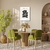 Quadro decorativo Matisse com flores pretas em um ambiente moderno com mesa e cadeiras verdes.