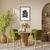 Quadro decorativo Matisse com flores pretas em um ambiente moderno, com mesa e cadeiras verdes.