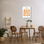 Quadro decorativo Matisse com recortes em laranja, em ambiente de sala de jantar moderno.