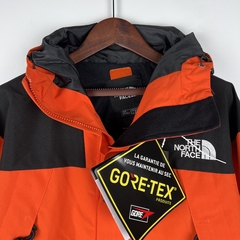Jaqueta Corta-Vento The North Face Laranja e Preta na internet