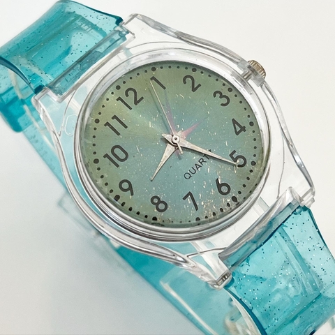RELOJ TRANSPARENTE CHICO CELESTE CAUCHO GLITTER K13C