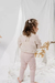 Beba con calza Darien, en rosa con estampa off white, combinada con el buzo Bamboo bebé natural