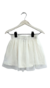 Pollera de nena confeccionada en tul plumetí color off white con forro de jersey de algodón y cintura con elástico. 
