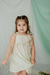 Nena con vestido Nacar, rayado con lurex, y detalle de broderie en pechera