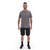 Homem sorrindo usando camiseta casual masculina cinza da Marcio May Sports e shorts pretos.