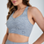 Top feminino cinza mescla de fitness, destacando alças largas e design confortável.