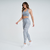 Modelo usando calça legging feminina cinza mescla da Marcio May Sports, ideal para atividades fitness.