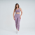 Calça legging feminina rosa mescla da Marcio May Sports, modelo Firenze, usada por uma mulher em pé.