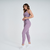 Calça legging feminina rosa mescla da Marcio May Sports, ideal para atividades físicas, combinada com top esportivo e tênis brancos.