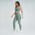 Modelo usando calça legging feminina verde mescla da Marcio May Sports, ideal para atividades físicas.