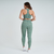 Calça legging feminina verde mescla da Marcio May Sports, vista traseira, ideal para atividades fitness.