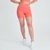 Shorts femininos laranja da marca Marcio May, ideal para atividades físicas, com detalhe em relevo nas laterais.