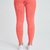 Calça legging feminina laranja com detalhes texturizados, vista traseira.