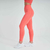 Conjunto de kit top e calça legging na cor laranja, modelagem ajustada, ideal para atividades físicas.