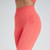 Calça legging feminina na cor laranja, destacando detalhes de costura e ajuste no corpo.