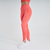 Calça legging feminina laranja da marca Marcio May, ideal para atividades físicas, destacando-se pelo design moderno e ajuste confortável.