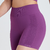 Shorts femininos roxos da marca Marcio May, com detalhes em relevo e cintura alta, ideais para atividades físicas.