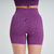 Shorts feminino roxos da linha Marcio May Sports, vista traseira, destacando o design e a textura do tecido.