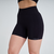 Shorts femininos preto da marca Marcio May, com design fitness e detalhes em relevo nas laterais.