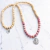 JAPA MALA DE RODONITA Y MADERA, AMULETO GANESHA