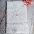 Fralda de batizado personalizada com bordado de flores, data e nome "Aurora".