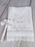 Toalha de batismo de cambraia de linho com bordado de flores lilás e vela decorada.