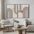 Composição de dois quadros decorativos com linhas curvas e formas geométricas em um ambiente moderno.