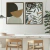 Dois quadros decorativos com temas botânicos, um com formas geométricas e outro com folhas estilizadas, em um ambiente moderno e minimalista.