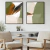 Dois quadros decorativos em estilo moderno, com cores suaves e formas abstratas, emoldurados em preto, expostos em uma sala de estar minimalista.