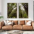 Dois quadros decorativos com imagens de uma floresta, exibindo árvores altas e vegetação exuberante, pendurados em uma parede acima de um sofá de couro marrom.