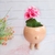 Maceta decorativa en forma de cerdito, color beige, con dos patas cortas y detalles faciales.