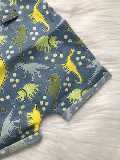 Jardineira Ilhós Dinossauros Azul Jeans na internet