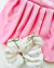 Conjunto de saia rosa plissada e blusa moletom tricô com laços strass Fabiana - loja online
