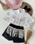 Conjunto de short e camisa branca boiadeira com franjas boiadeira Jú