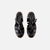 Sandalias Romas negras con diseño trenzado y hebilla lateral.