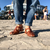 Sandalias Romas de cuero marrón con suela, vistas desde abajo, combinadas con jeans enrollados.
