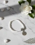 Pulseira Cristais e Pingente Medalha Axé prateada